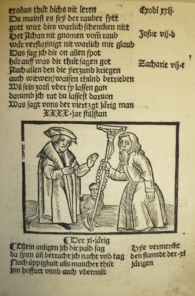 Ein Blatt Papier mit gedrucktem Text in einer fremden Sprache, mit zwei Männern im Hintergrund, möglicherweise aus einem Schulbuch.